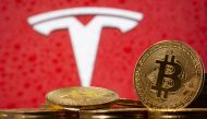 FILE PHOTO: Representations of virtual currency bitcoin are seen in front of Tesla logo in this illustration taken, February 9, 2021. REUTERS/Dado Ruvic/File Photo
