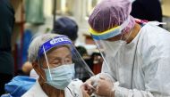 A medical worker administers a dose of the vaccine against the coronavirus disease (COVID-19) for a man during a vaccination session for elderly people over 85 years old, at a school in Taipei, Taiwan June 15, 2021. Reuters/Ann Wang