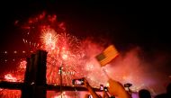 FILE PHOTO: People watch the Macy's 4th of July Firework Show over the Brooklyn Bridge in New York, U.S., July 4, 2019. REUTERS/Eduardo Munoz/File Photo
