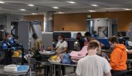 Travellers line up to enter a Transportation Safety Administration (TSA) checkpoint at Detroit Metropolitan Wayne County Airport in Detroit, Michigan, U.S. June 12, 2021. Reuters/Seth Herald