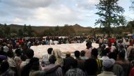 FILE PHOTO: People stand in line to receive food donations, at the Tsehaye primary school, which was turned into a temporary shelter for people displaced by conflict, in the town of Shire, Tigray region, Ethiopia, March 15, 2021. Picture taken March 15, 2