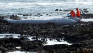 Rescue workers search for bodies after a boat with 46 migrants from the Maghreb region capsized in the beach of Orzola, in the Canary Island of Lanzarote, Spain June 18, 2021. REUTERS/Borja Suarez