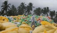 A Sri Lankan navy member walks past the sacks of collected debris washed to a beach from the MV X-Press Pearl container ship which caught fire and sunk off the Colombo Harbour, in Ja-Ela, Sri Lanka June 14, 2021. Reuters/Dinuka Liyanawatte