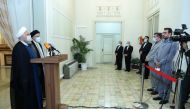 Iran's outgoing President Hassan Rouhani and Iran's President-elect Ebrahim Raisi speak to the media after their meeting in Tehran, Iran June 19, 2021. (Official Presidential website/Handout via REUTERS)