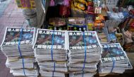 Copies of the final edition of Apple Daily, published by Next Digital, are seen at a newsstand in Hong Kong, China June 24, 2021. REUTERS/Lam Yik