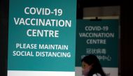 A woman walks into a newly set up coronavirus disease (COVID-19) vaccination center which will be opened to the public the day after, in Singapore January 26, 2021. REUTERS/Edgar Su/File Photo