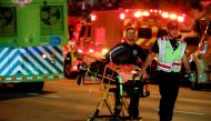 Emergency personnel work at the scene of a partial building collapse in Surfside near Miami Beach, Florida, U.S., June 24, 2021. REUTERS/Marco Bello 
