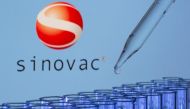 File photo: Test tubes are seen in front of a displayed Sinovac logo in this illustration taken, May 21, 2021. Reuters/Dado Ruvic/Illustration/File Photo
