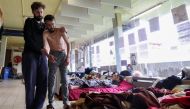 Youssef Bouzidi, a Moroccan asylum seeker, requesting to be regularised by the Belgian government to have access to healthcare, and who is going on hunger strike for more than a month, is helped by a person in a room on the campus of Belgium university UL