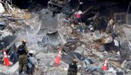 Emergency workers conduct search and rescue efforts at the site of a partially collapsed residential building in SURFSIDE, near Miami Beach, Florida, U.S., June 30, 2021. REUTERS/Joe Skipper

