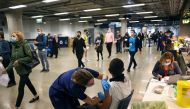 FILE PHOTO: A person receives a dose of the Pfizer BioNTech COVID-19 vaccine at a mass vaccination centre for those aged 18 and over at the Tottenham Hotspur Stadium, amid the coronavirus disease (COVID-19) pandemic, in London, Britain, June 20, 2021. REU