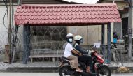 People wearing protective masks ride across a street outside an area under enhanced lockdown, amid the coronavirus disease (COVID-19) outbreak, in Kuala Lumpur, Malaysia June 29, 2021. REUTERS/Lim Huey Teng