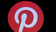 FILE PHOTO: Screens display the company logo for Pinterest Inc. during the company's IPO on the front of the New York Stock Exchange (NYSE) in New York, U.S., April 18, 2019. REUTERS/Brendan McDermid/File Photo
