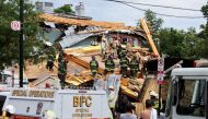 Emergency personnel clear debris as they search for trapped construction workers after a building undergoing construction collapsed in Washington, U.S., July 1, 2021. REUTERS/Evelyn Hockstein
