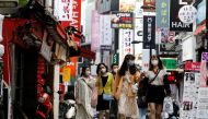 FILE PHOTO: People wearing masks walk at Myeongdong shopping district amid social distancing measures to avoid the spread of the coronavirus disease (COVID-19), in Seoul, South Korea, May 28, 2020. REUTERS/Kim Hong-Ji/File Photo
