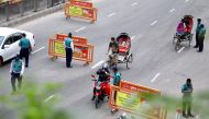 Police officers check commuters at a checkpost during a countrywide lockdown, in Dhaka, Bangladesh, July 1, 2021. REUTERS/Mohammad Ponir Hossain
