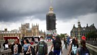 People, some wearing protective face masks, walk over Westminster Bridge, amid the coronavirus disease (COVID-19) pandemic, in London, Britain, July 4, 2021. REUTERS/Henry Nicholls/File Photo