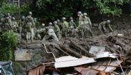 Members of Japanese Self-Defence Forces conduct rescue and search operartion at a mudslide site caused by heavy rain at Izusan district in Atami, west of Tokyo, Japan July 5, 2021, in this photo taken by Kyodo. Kyodo/via REUTERS