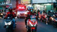 Volunteer bikers escort an ambulance to a cemetery as coronavirus disease (COVID-19) cases surge in Depok on the outskirts of Jakarta, Indonesia, July 2, 2021. Picture taken July 2, 2021 REUTERS/Ajeng Dinar Ulfiana