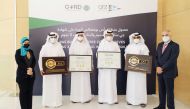 Officials posing with the certificates during the award ceremony.