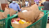 Paper bags were distributed to customers at Al Meera on the International Plastic Bag Free Day.