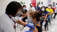 A health worker administers a dose of the Russian Sputnik V COVID-19 vaccine, as economic workers queue to get vaccinated at Robinsons Place, in Manila, Philippines, June 8, 2021. REUTERS/Eloisa Lopez
