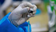 A healthcare worker prepares a dose of China's Sinovac Biotech vaccine against the coronavirus disease (COVID-19) during a mass vaccination program for domestic flight passengers, at Soekarno-Hatta International Airport in Tangerang, near Jakarta, Indones