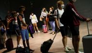 Young people wait to take a voluntary antigen test for the coronavirus disease (COVID-19) after coming back from vacationing in Salou at the bus station in Pamplona, Spain, July 4, 2021. REUTERS/Susana Vera