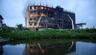 Flames rise the morning after a fire broke out at a factory named Hashem Foods Ltd. in Rupganj of Narayanganj district, on the outskirts of Dhaka, Bangladesh, July 9, 2021. REUTERS/Mohammad Ponir Hossain
