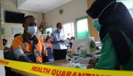 A worker undergoes health screening at a port health office before receiving his dose of the coronavirus disease (COVID-19) vaccine, in Riau province, Indonesia July 9, 2021. Antara Foto/Aswaddy Hamid/via REUTERS
