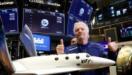 FILE PHOTO: Sir Richard Branson poses on the floor of the New York Stock Exchange (NYSE) ahead of Virgin Galactic (SPCE) trading in New York, U.S., October 28, 2019. REUTERS/Brendan McDermid