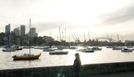 A woman wearing a protective face mask walks along a waterfront path during a lockdown to curb the spread of a coronavirus disease (COVID-19) outbreak in Sydney, Australia, July 8, 2021. REUTERS/Loren Elliott/File Photo/File Photo