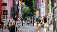 People wearing masks walk in a shopping district amid the coronavirus disease (COVID-19) pandemic in Seoul, South Korea, July 9, 2021. REUTERS/ Heo Ran/File Photo