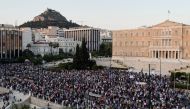 Anti-vaccine protesters take part in a demonstration outside the parliament building after the government announced mandatory vaccinations for certain sectors, in Athens, Greece, July 14, 2021. REUTERS/Vassilis Triandafyllou

