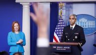 A journalist raises a hand to ask a question during United States Surgeon General Vivek Murthy’s remarks at a news conference with White House Press Secretary Jen Psaki at the White House in Washington, U.S., July  15, 2021. REUTERS/Tom Brenner
