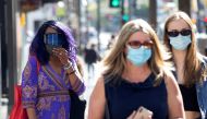 FILE PHOTO: People wearing face protective masks walk on Hollywood Blvd during the outbreak of the coronavirus disease (COVID-19), in Los Angeles, California, U.S., March 29, 2021. REUTERS/Mario Anzuoni/File Photo
