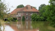 High water is seen near a house, in Roermond, Netherlands, July 16, 2021. REUTERS/Eva Plevier
