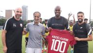 Qatar Football Association President Sheikh Hamad bin Khalifa bin Ahmed Al Thani, coach Felix Sanchez and captain Hassan Al Haydos with Abdelkarim Hassan.