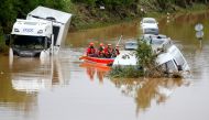Rescue team paddle along flooded cars stuck on the road following heavy rainfalls in Erftstadt, Germany, July 16, 2021. REUTERS/Thilo Schmuelgen/File Photo