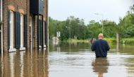 A person wades through water during a flood in Guelle, Netherlands, July 16, 2021. REUTERS/Eva Plevier