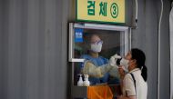 A woman gets a coronavirus disease (COVID-19) test at a coronavirus testing site in Seoul, South Korea, July 15, 2021. REUTERS/Kim Hong-Ji