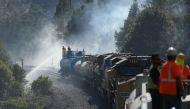 Firefighters assigned to the Union Pacific Fire Train protect the tracks and hinder the Dixie Fire from crossing the North Fork of the Feather River in Plumas National Forest, California, U.S., July 17, 2021. REUTERS/David Swanson