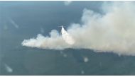 A plane makes a water drop to fight a forest fire in the region of Yakutia in eastern Siberia, Russia, in this still image taken from video released July 14, 2021. Ministry of Defence of the Russian Federation/Handout via REUTERS