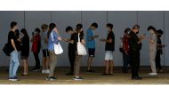 People who had visited a mall which became a coronavirus disease (COVID-19) cluster, queue up for their swab tests in Singapore May 20, 2021. REUTERS/Edgar Su/File Photo