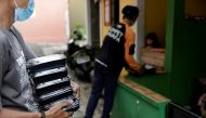 Volunteers of Indonesian NGO Dompet Dhuafa distribute free food to coronavirus disease (COVID-19) patients undergoing self-isolation in South Tangerang, on the outskirts of Jakarta, Indonesia, July 11, 2021. REUTERS/Willy Kurniawan