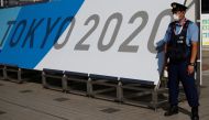 A police officer wearing a face mask stands near the entrance of the Main Press Centre, ahead of the Tokyo 2020 Olympic Games, in Tokyo, Japan, July 19, 2021. REUTERS/Phil Noble