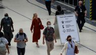 Commuters walk past a sign, amid the coronavirus disease (COVID-19) pandemic, in Waterloo station, London, Britain, July 19, 2021. REUTERS/Peter Nicholls
