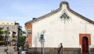 People wearing protective face mask walk past a temple amid the coronavirus disease (COVID-19) pandemic, in Taipei, Taiwan, July 16, 2021. REUTERS/Ann Wang