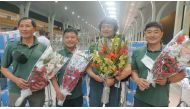 South Korean climber Kim Hong-Bin (2nd R) along with team members hold bouquets at the airport in Islamabad, Pakistan June 16, 2021. Picture taken June 16, 2021. Karrar Haidri/Alpine Club of Pakistan/Handout via REUTERS