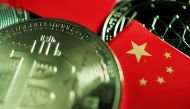 A Chinese flag is seen among representations of Bitcoin and other cryptocurrencies in this illustration picture. (REUTERS/Florence Lo/Illustration/File Photo)